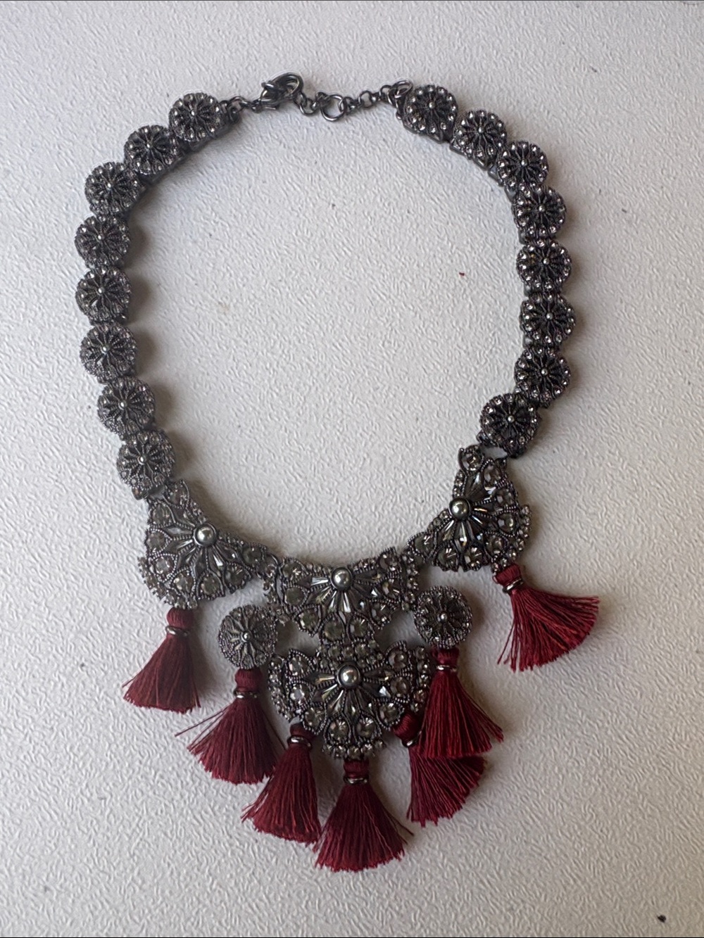 Ornate Silver-Tone Filigree Necklace with Burgundy Tassels